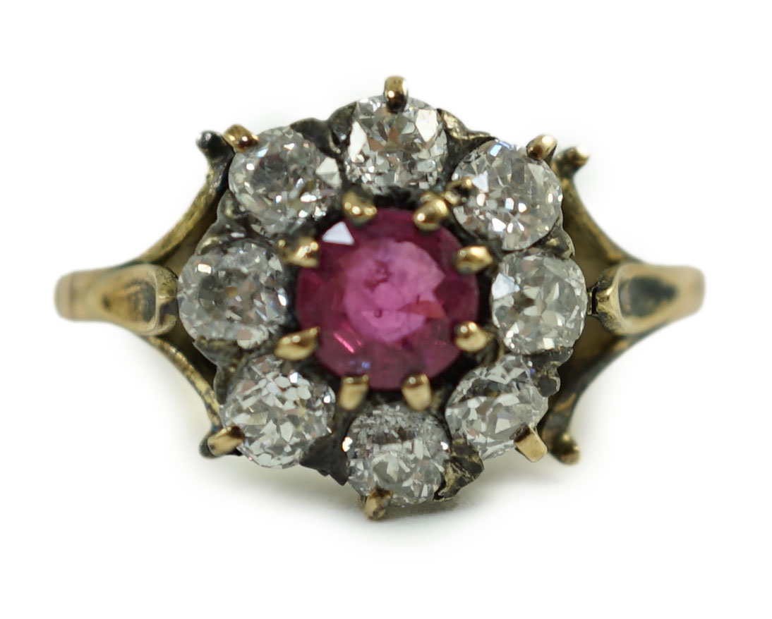 An antique gold, ruby and old cut diamond set circular cluster ring